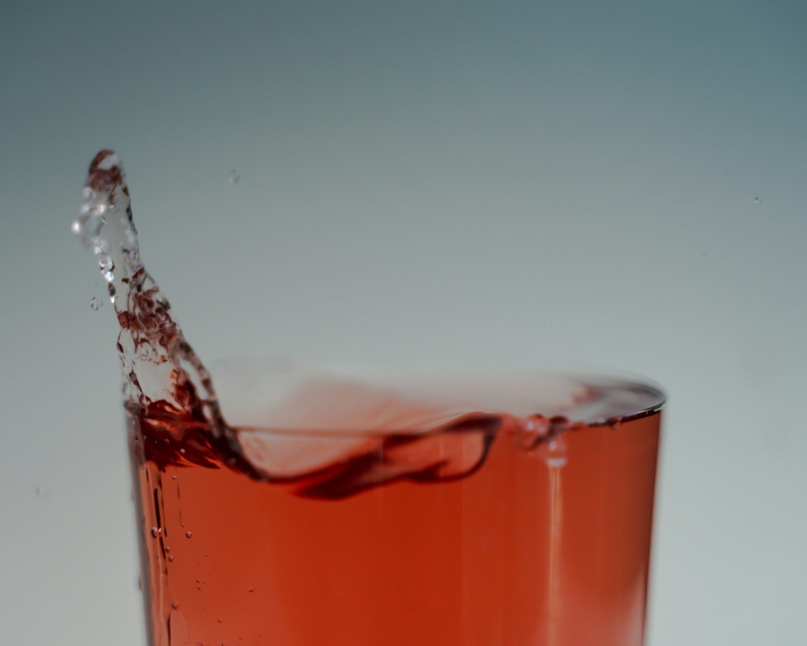A glass overflowing — one drop is all it takes when it's already full.